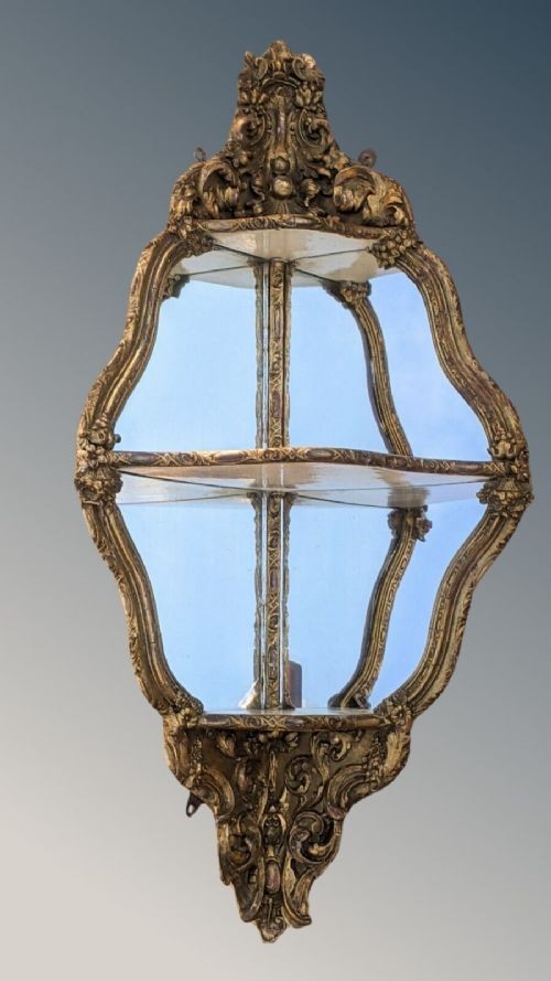 An ornate Rococo gilded wood wall bracket featuring mirrored back panels, serpentine frame, and decorative carved scrollwork. View VII