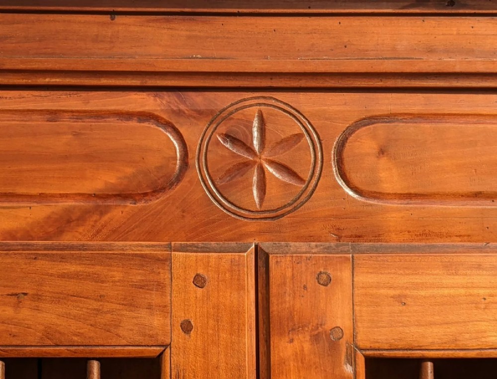 A French provincial fruitwood pantry cabinet featuring upper spindle-front doors, two central drawers with steel handles, lower solid panel doors, and carved cabriole feet. View III
