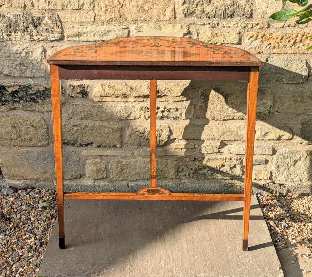 A Regency satinwood demilune side table featuring hand-painted floral garlands and slender tapered legs. View VIII