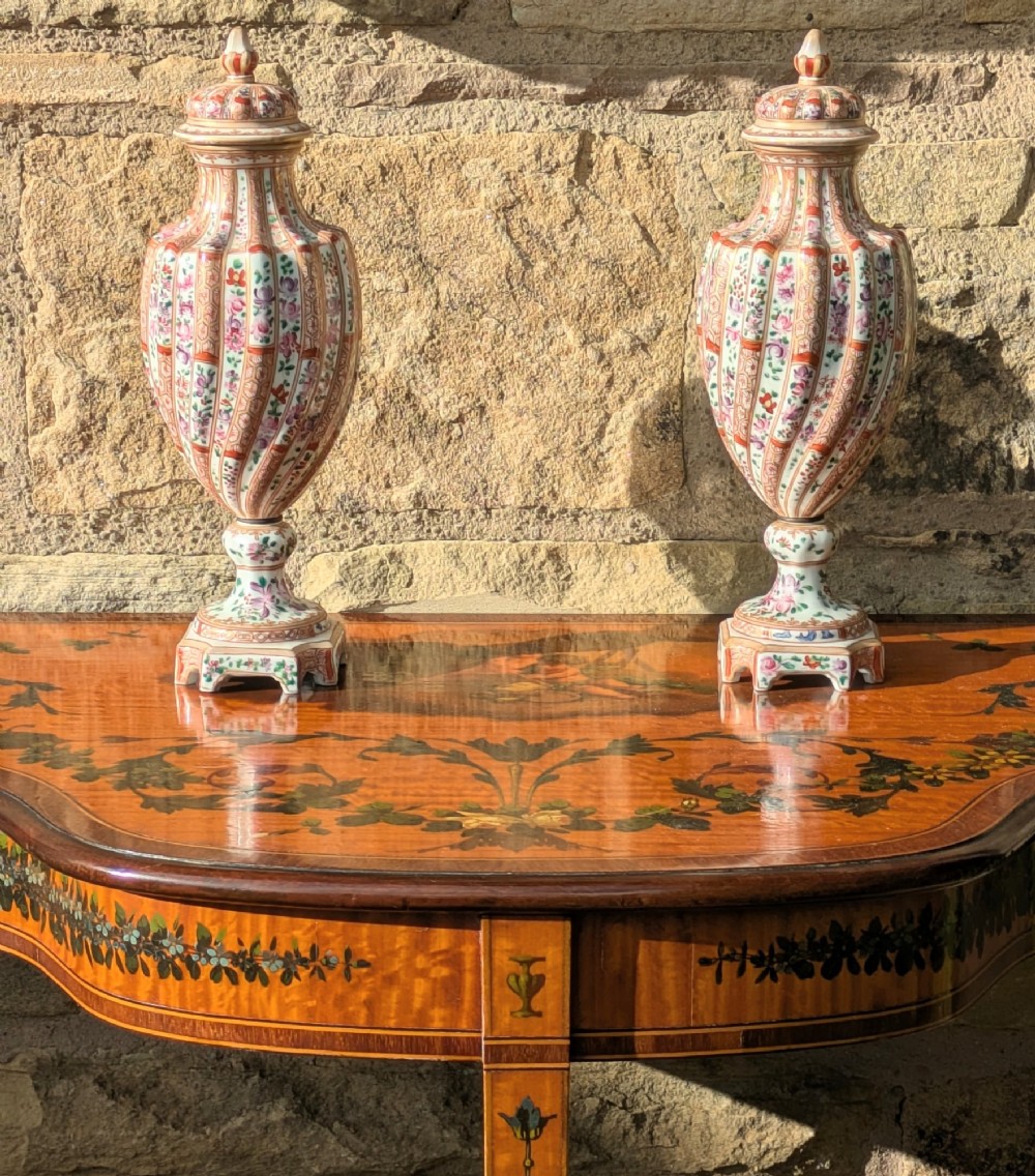 A Regency satinwood demilune side table featuring hand-painted floral garlands and slender tapered legs. View X