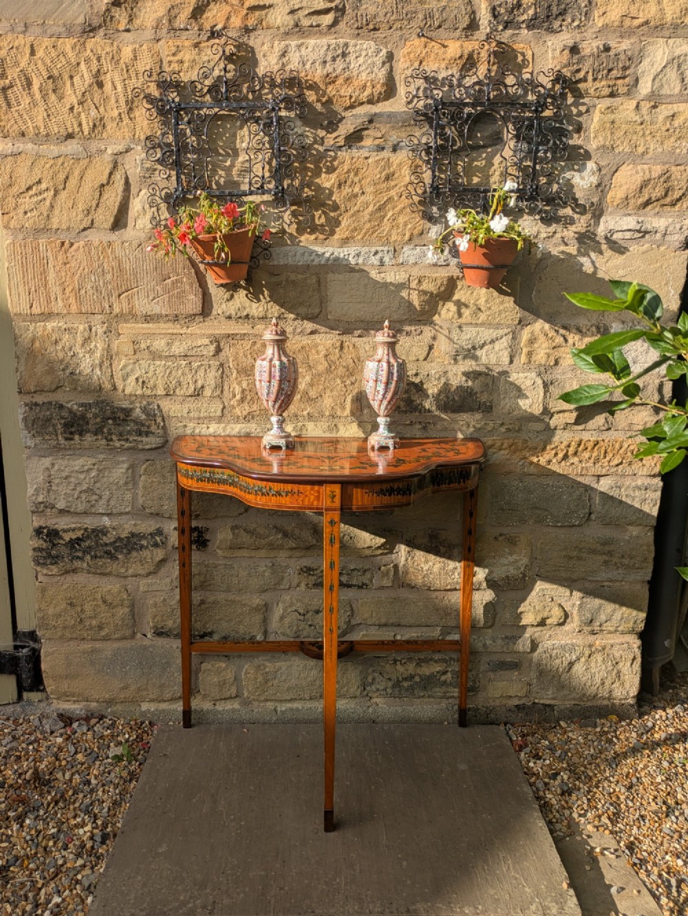 A Regency satinwood demilune side table featuring hand-painted floral garlands and slender tapered legs. View XI