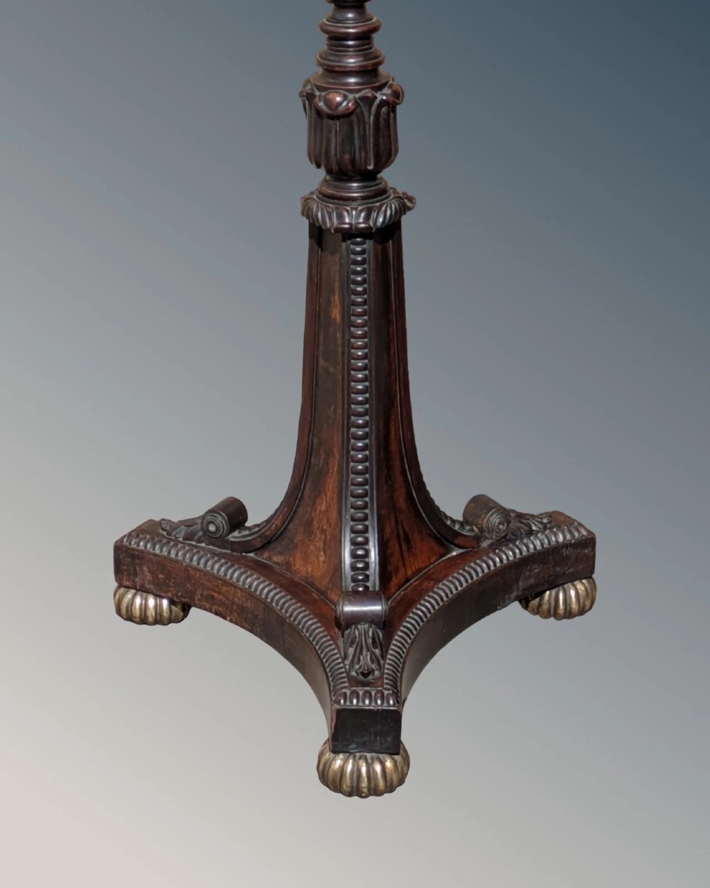 A dark rosewood Regency standard lamp featuring a barley twist column, a carved triform base with brass feet, and a cream fabric shade. View V