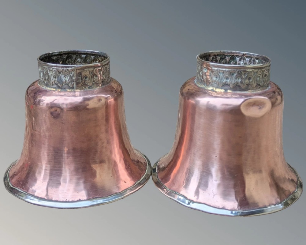 A pair of antique Tibetan flared drinking vessels with hand-hammered copper bodies, silver-lined interiors, and carved silver bases. View VII