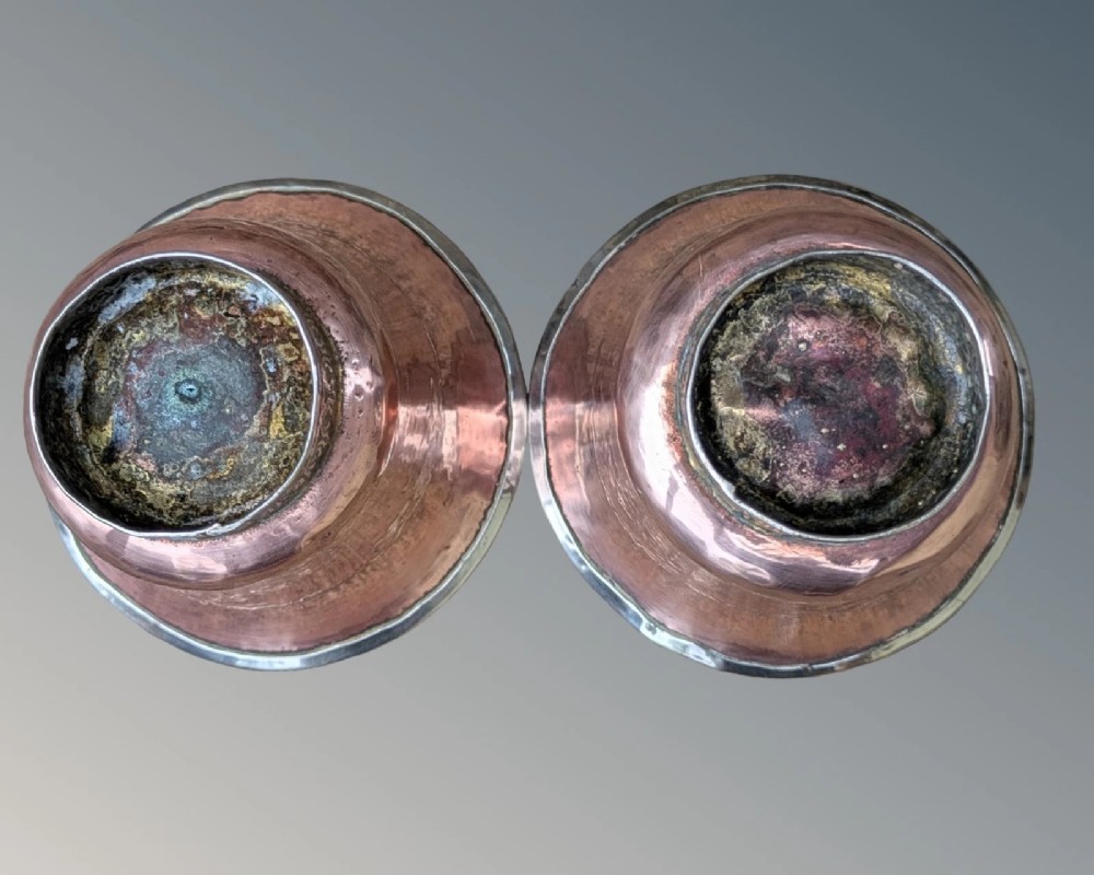 A pair of antique Tibetan flared drinking vessels with hand-hammered copper bodies, silver-lined interiors, and carved silver bases. View VIII
