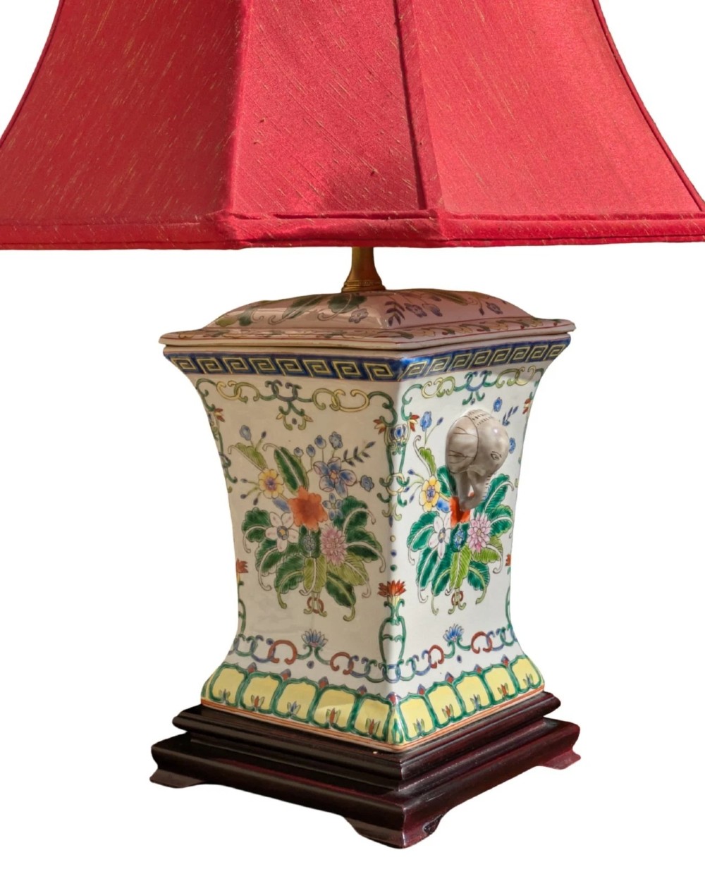 A pair of Chinese porcelain table lamps featuring hand-painted floral motifs and relief elephant details, topped with red silk shades. View IV