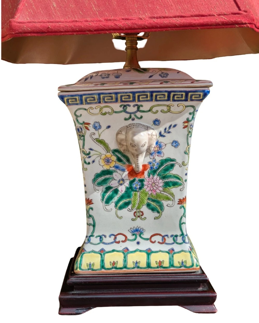 A pair of Chinese porcelain table lamps featuring hand-painted floral motifs and relief elephant details, topped with red silk shades. View V