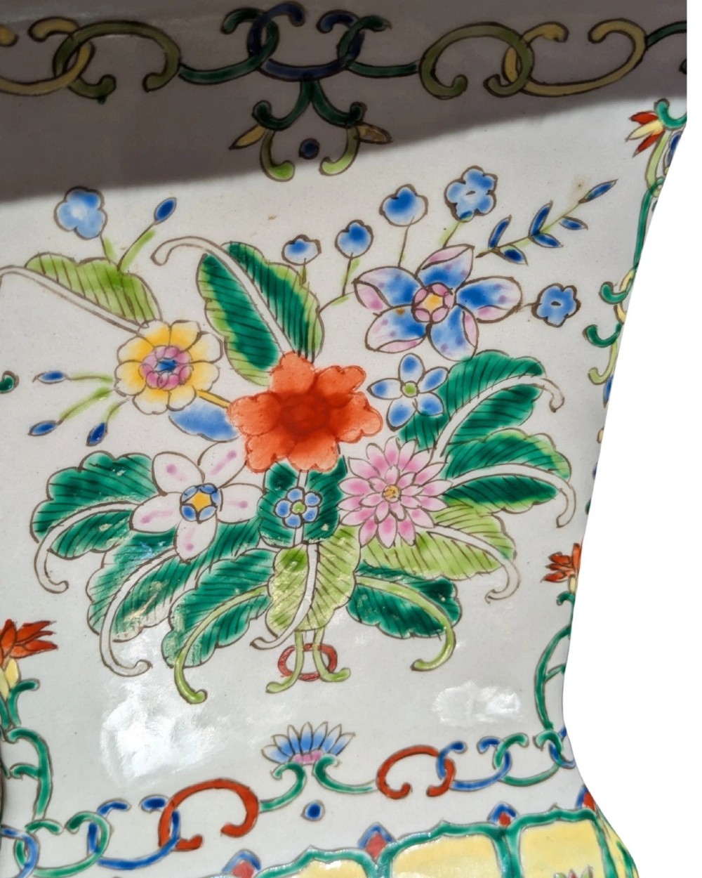 A pair of Chinese porcelain table lamps featuring hand-painted floral motifs and relief elephant details, topped with red silk shades. View VII