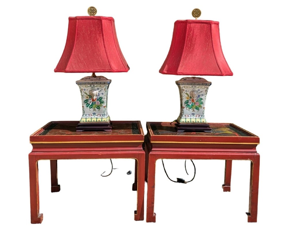 A pair of Chinese porcelain table lamps featuring hand-painted floral motifs and relief elephant details, topped with red silk shades. View IX