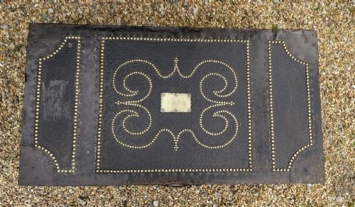A dark brown leather rectangular coffer decorated with brass stud patterns, scrolling motifs, and a central metal latch. View II