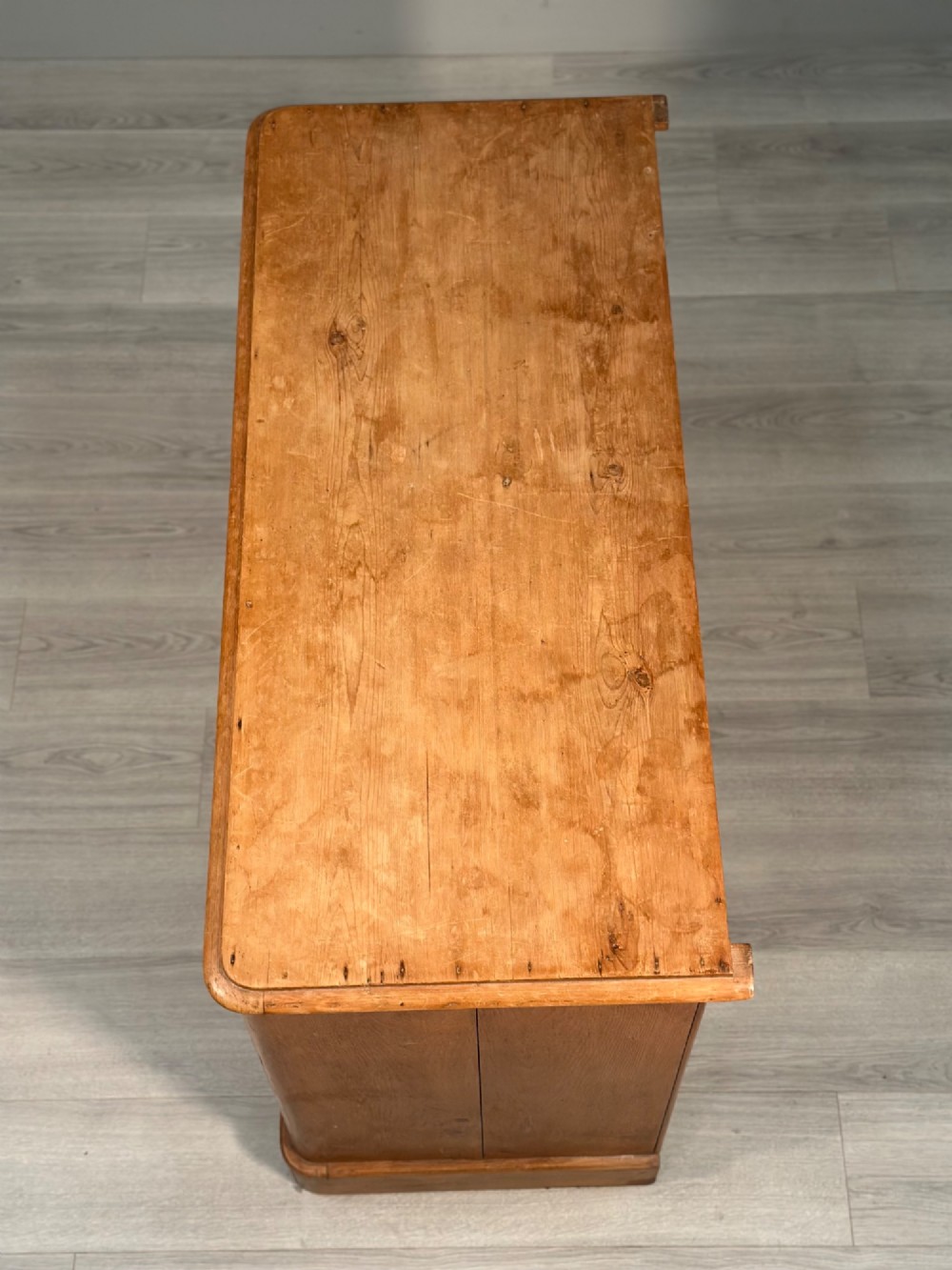 A nineteenth-century Victorian pine chest of drawers featuring a two-over-two drawer configuration, turned wooden knobs, and a solid plinth base. View XI