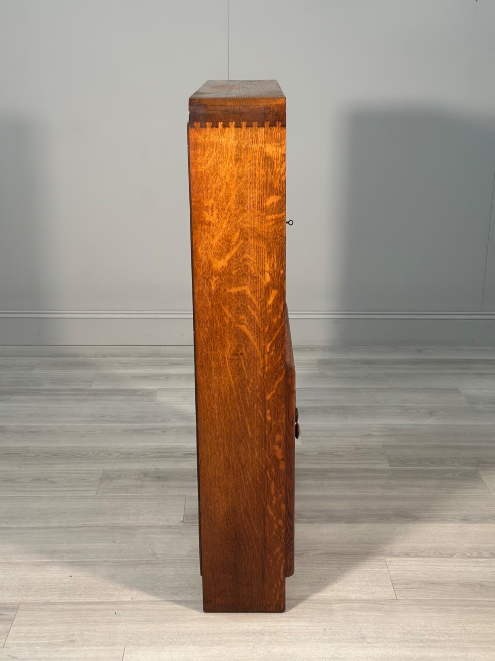 An Art Deco oak bureau bookcase featuring an open top shelf, drop-down writing flap, a glazed side cabinet, and lower cupboards with geometric diamond veneer. View XII