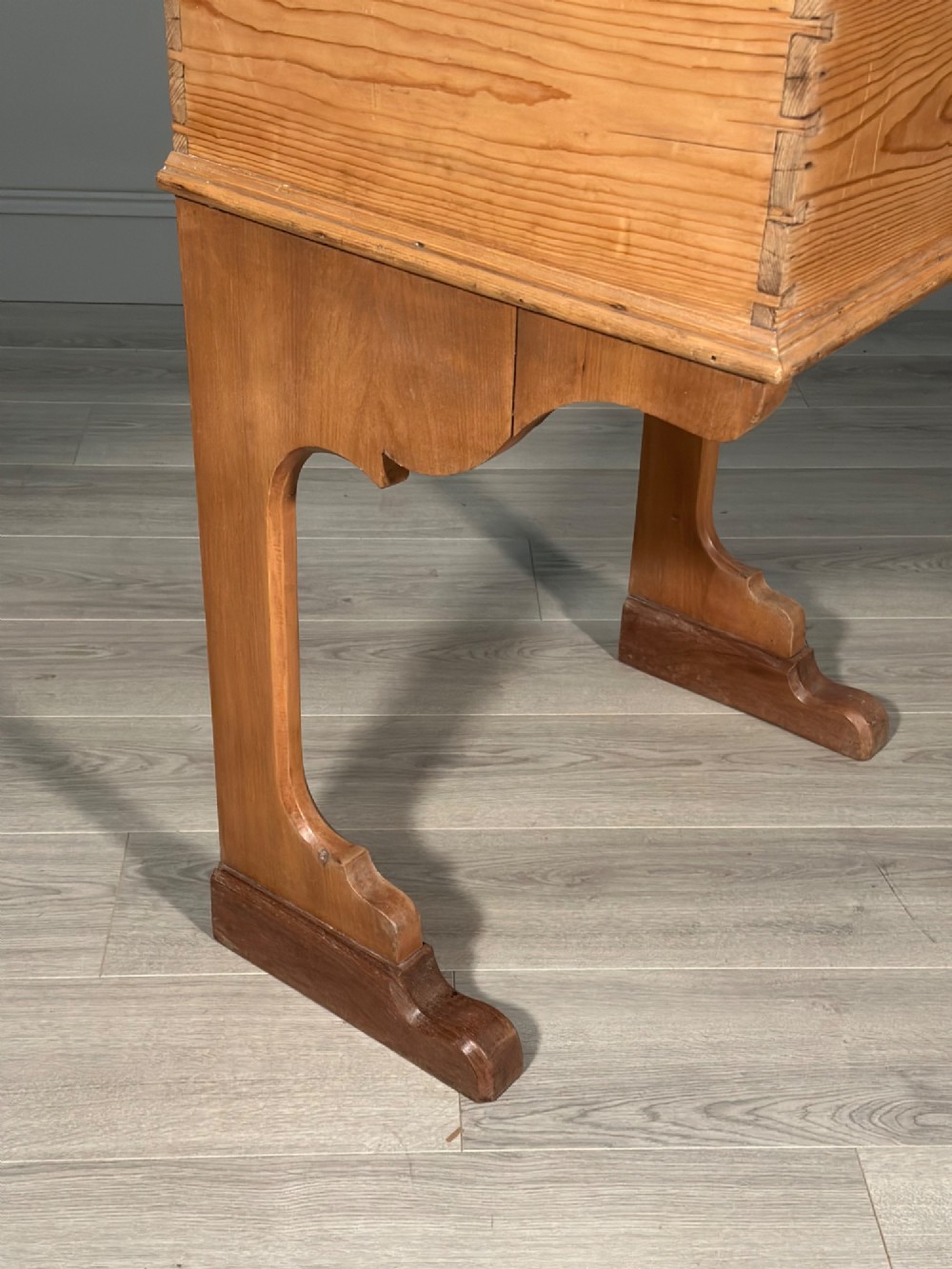 A Victorian pine school desk featuring a slanted hinged lid, dovetail joinery, shaped side supports, and a raised back gallery. View VI
