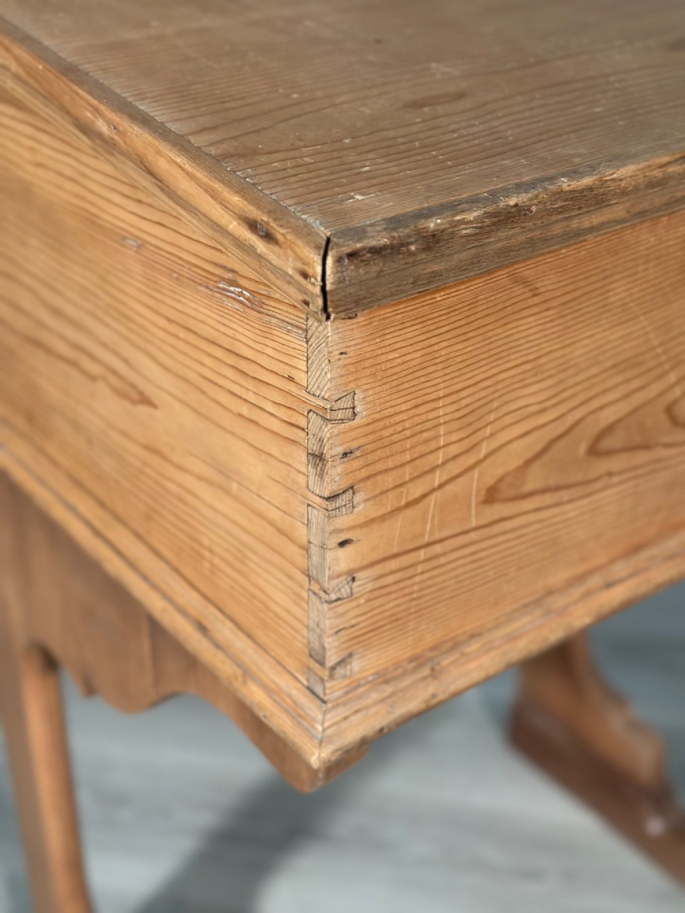 A Victorian pine school desk featuring a slanted hinged lid, dovetail joinery, shaped side supports, and a raised back gallery. View VII