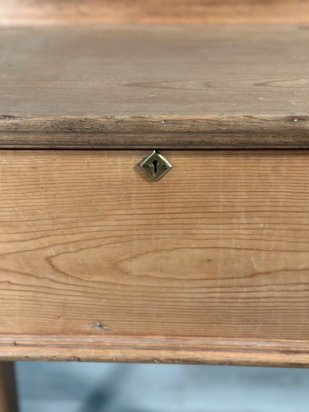 A Victorian pine school desk featuring a slanted hinged lid, dovetail joinery, shaped side supports, and a raised back gallery. View XI