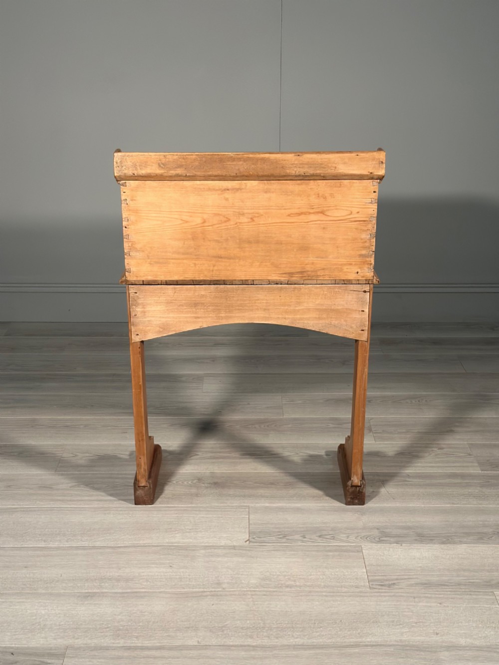 A Victorian pine school desk featuring a slanted hinged lid, dovetail joinery, shaped side supports, and a raised back gallery. View XII