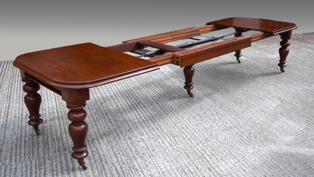 Large Antique Victorian five leg extending mahogany dining table  View III