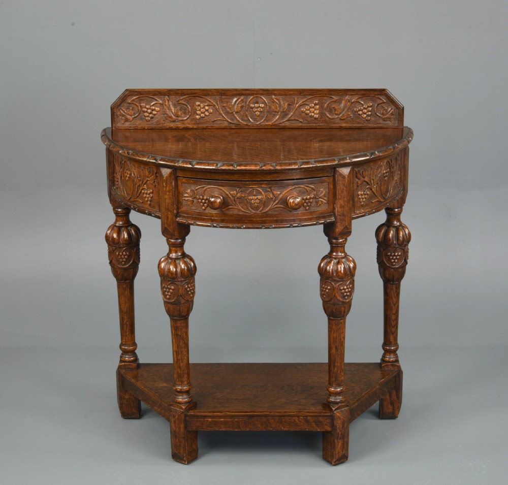 Carved oak demi lune hall side table 