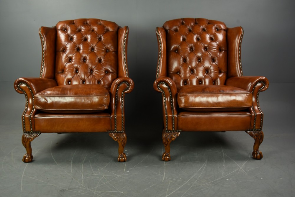 Pair of leather wing chairs 