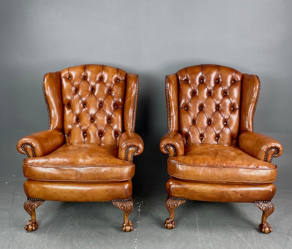 Antique pair of leather wing chairs 