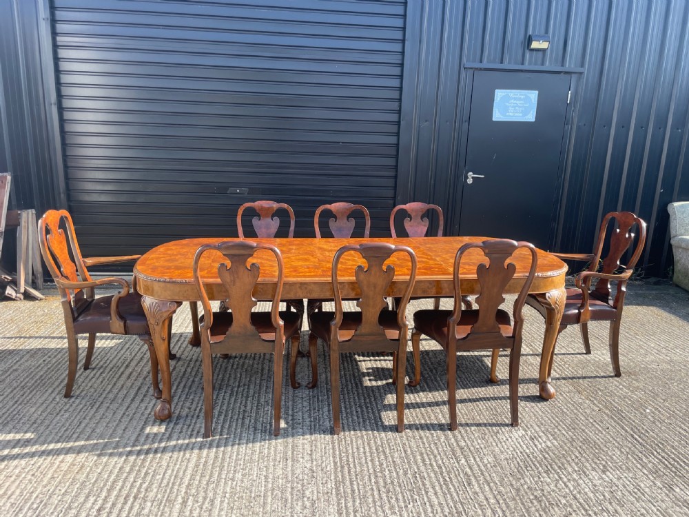Burr walnut Queen Anne style dining table and eight chairs 