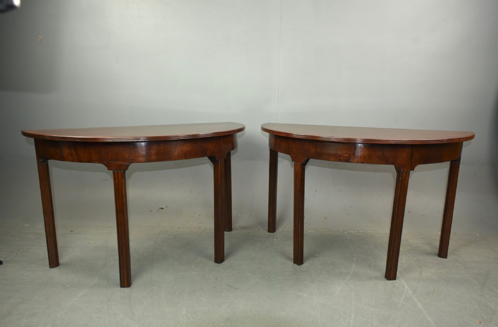 Pair of Georgian mahogany demi lune console tables 
