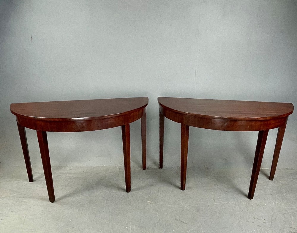 Pair of Georgian mahogany demi lune console tables 