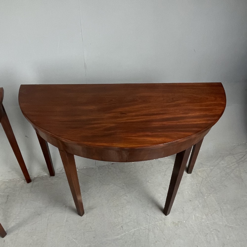 Pair of Georgian mahogany demi lune console tables  View II