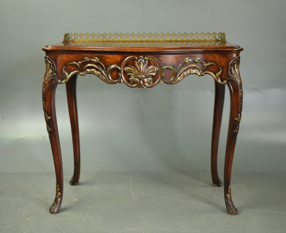 A 19th-century walnut side table with serpentine edges, ornate gilt metal mounts, cabriole legs, and a pierced brass gallery rail. View II