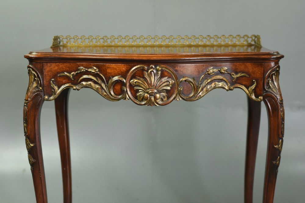 A 19th-century walnut side table with serpentine edges, ornate gilt metal mounts, cabriole legs, and a pierced brass gallery rail. View III