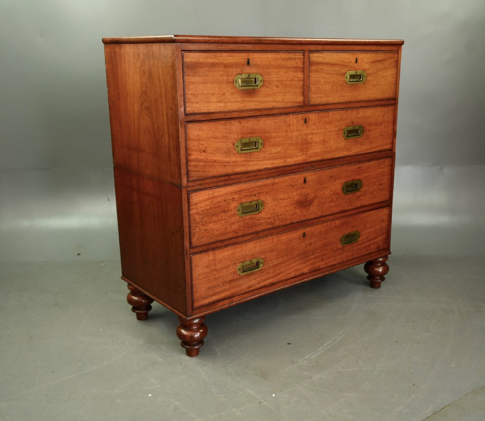 A Victorian mahogany military campaign chest featuring flush recessed brass handles, brass corner mountings, and a two-part construction resting on turned feet. View III