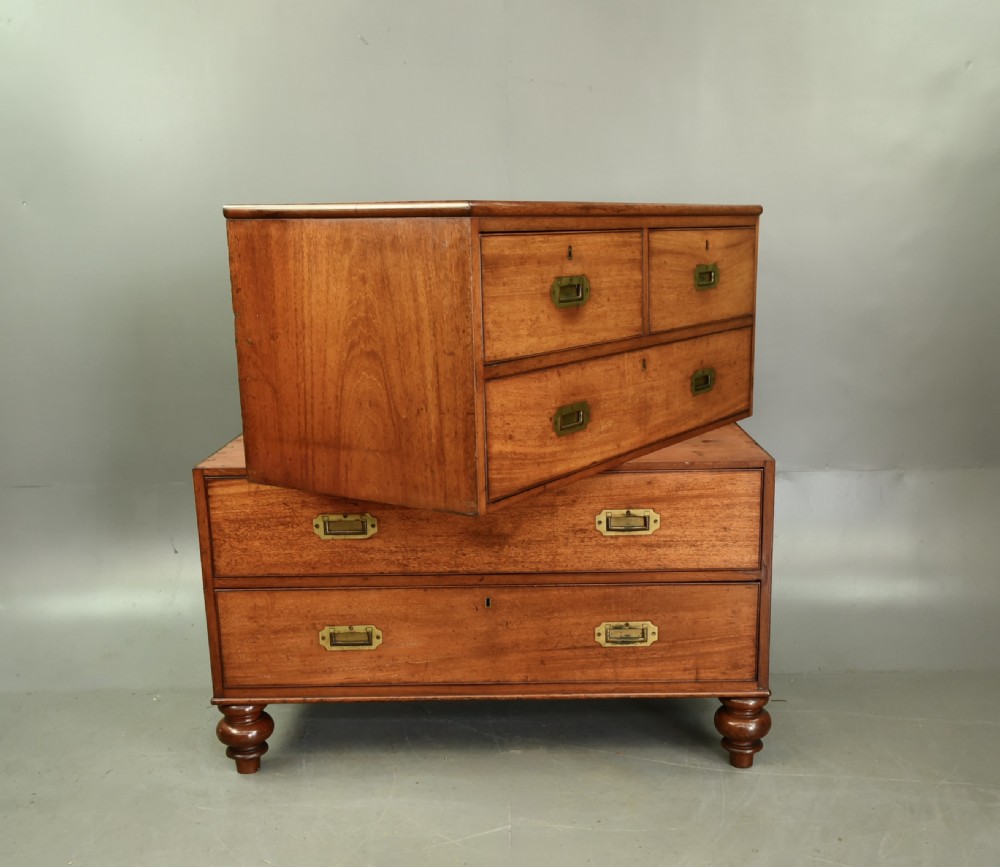 A Victorian mahogany military campaign chest featuring flush recessed brass handles, brass corner mountings, and a two-part construction resting on turned feet. View VIII