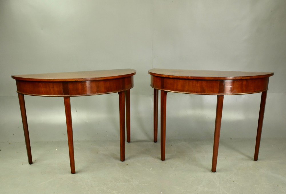 Pair of Georgian mahogany demi lune console tables 