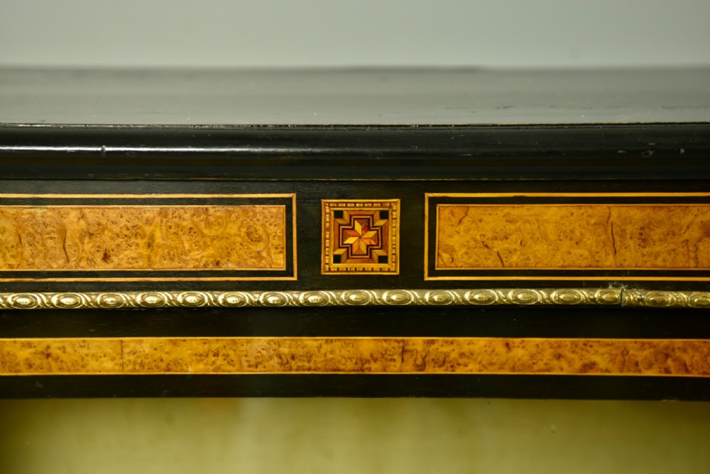 A pair of Victorian ebonised and burr walnut pier cabinets with glass doors, marquetry borders, and internal shelving. View III