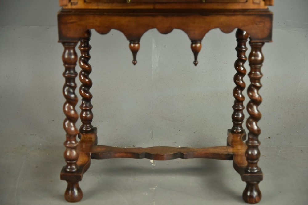 A small walnut bureau featuring an oval floral marquetry panel on the sloped front, set above a drawer and supported by four barley twist legs. View VIII