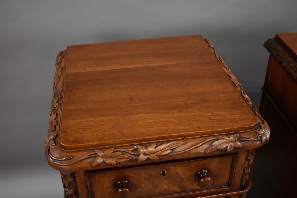 A pair of tall Victorian mahogany bedside chests with four drawers each, carved foliate columns, and turned wooden knobs on plinth bases. View VII