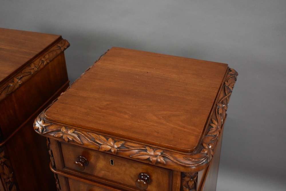 A pair of tall Victorian mahogany bedside chests with four drawers each, carved foliate columns, and turned wooden knobs on plinth bases. View VIII