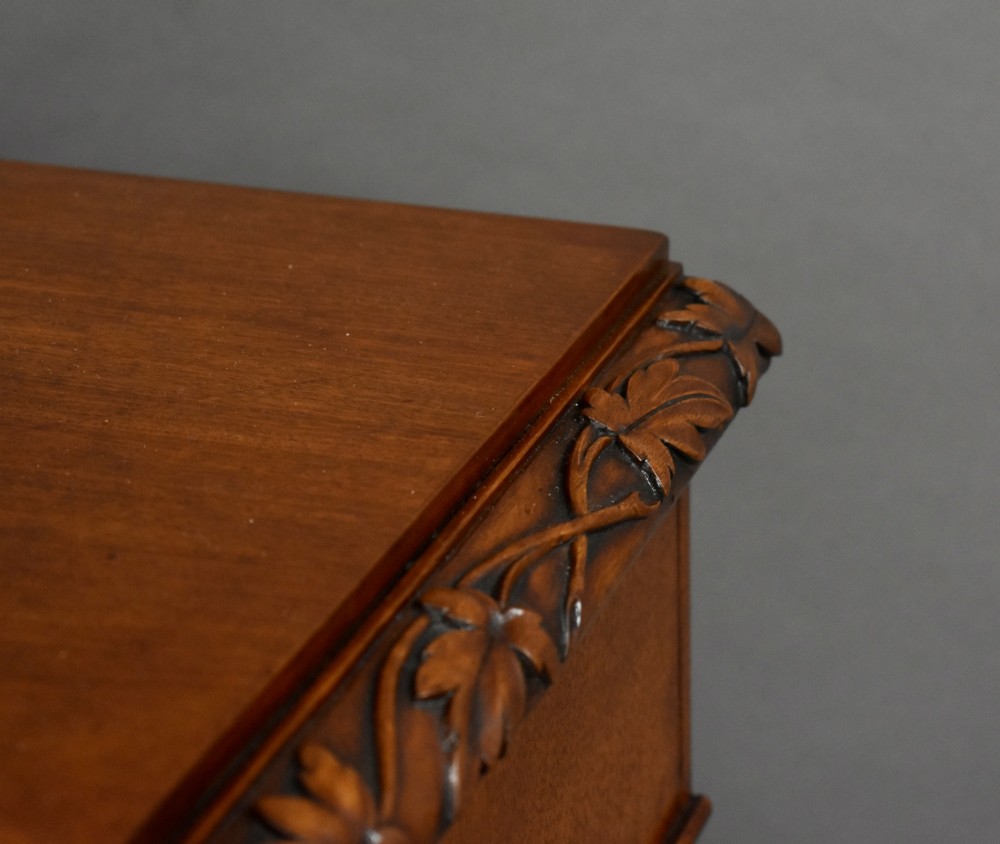 A pair of tall Victorian mahogany bedside chests with four drawers each, carved foliate columns, and turned wooden knobs on plinth bases. View IX