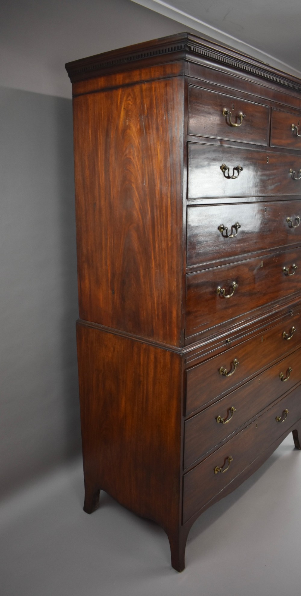 A two-section Georgian mahogany chest on chest featuring multiple drawers with brass swan-neck handles, a dentil cornice, and bracket feet. View IV
