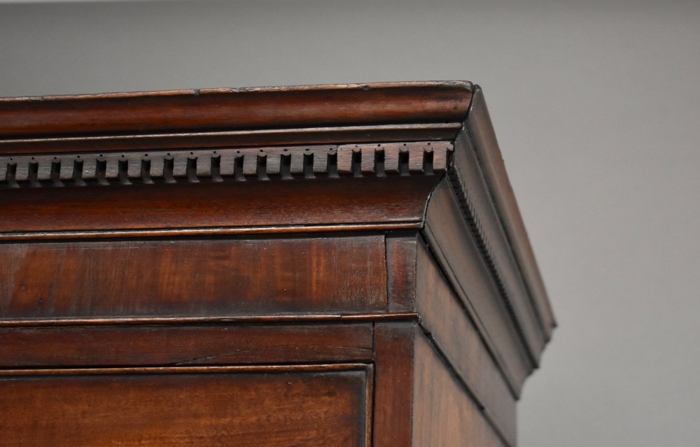 A two-section Georgian mahogany chest on chest featuring multiple drawers with brass swan-neck handles, a dentil cornice, and bracket feet. View VI