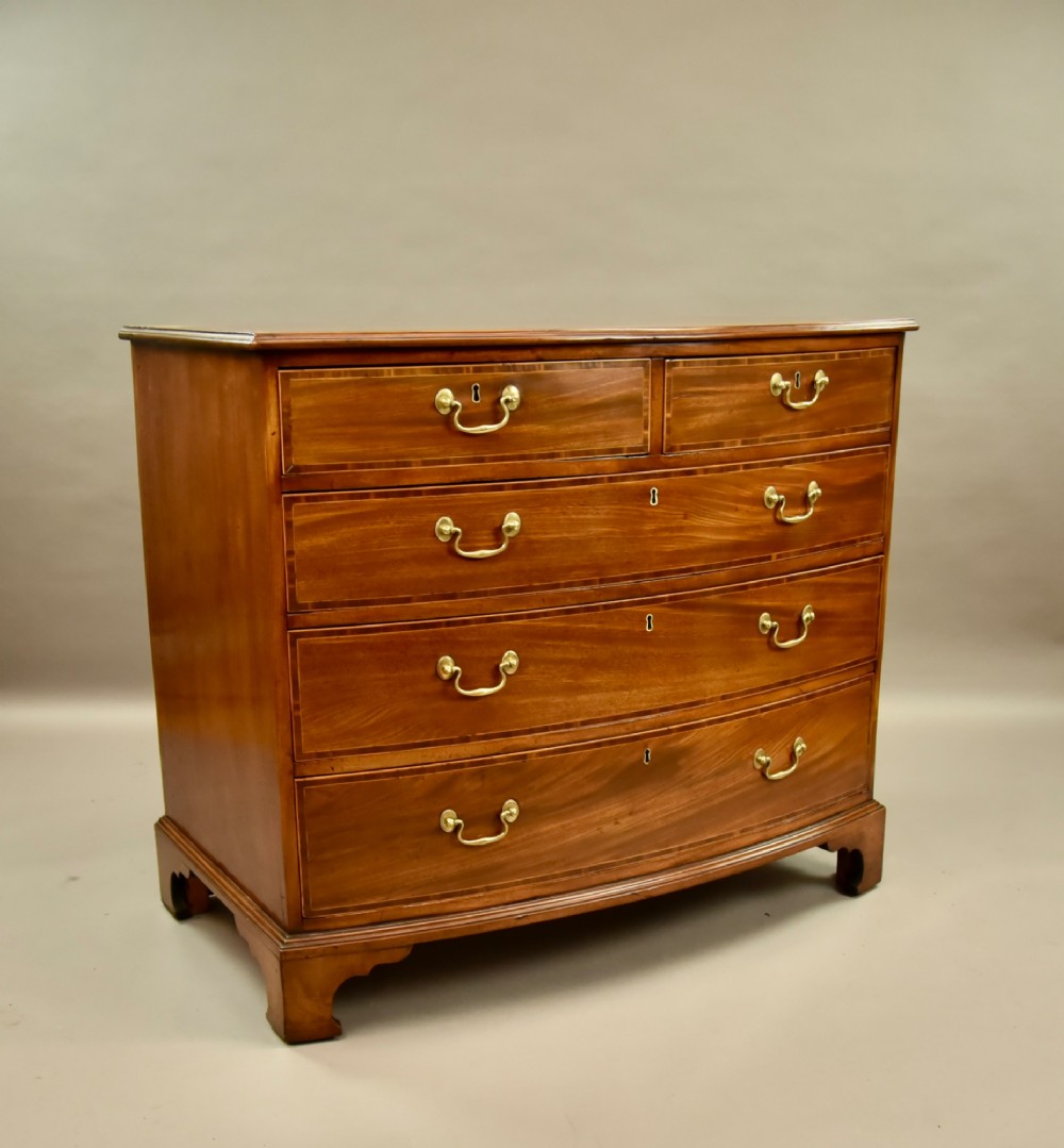 A 19th-century mahogany bowfront chest of drawers featuring two short over three long drawers with brass handles. View II