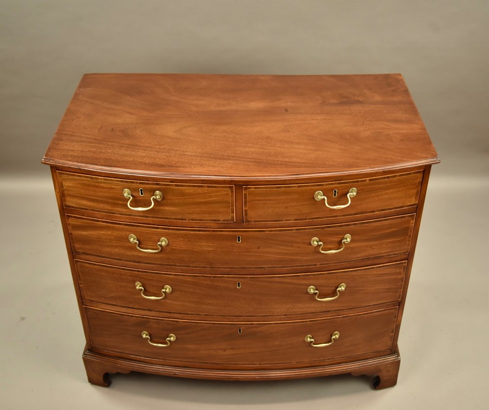 A 19th-century mahogany bowfront chest of drawers featuring two short over three long drawers with brass handles. View III