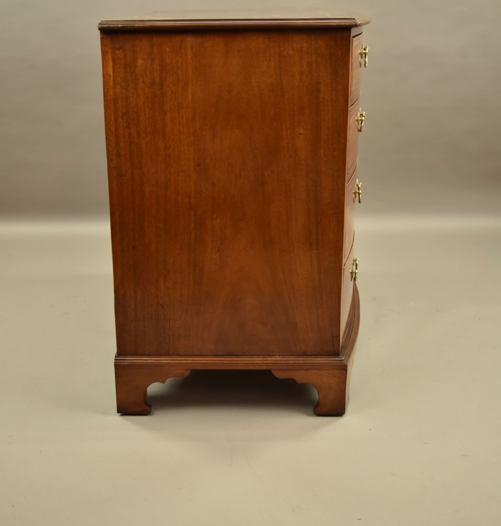 A 19th-century mahogany bowfront chest of drawers featuring two short over three long drawers with brass handles. View V