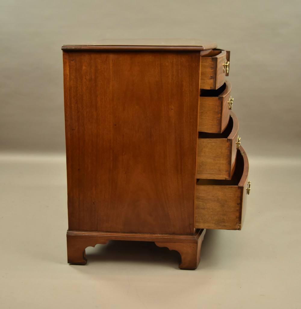 A 19th-century mahogany bowfront chest of drawers featuring two short over three long drawers with brass handles. View VI