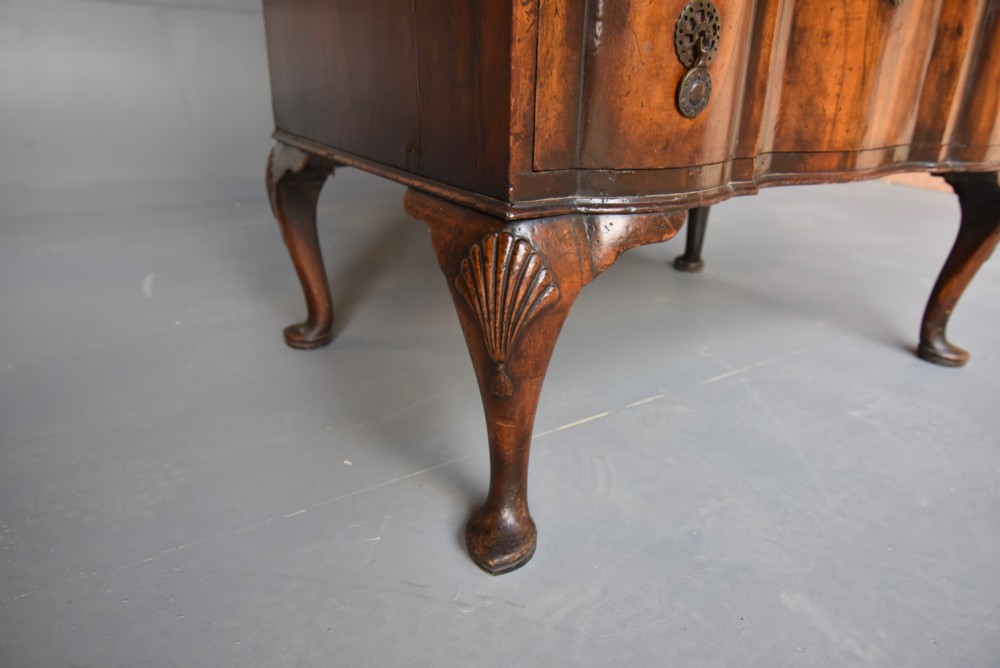An antique Queen Anne style bureau bookcase in warm walnut featuring a double-domed glazed top section above a slant-front bureau and three drawers on cabriole legs. View X