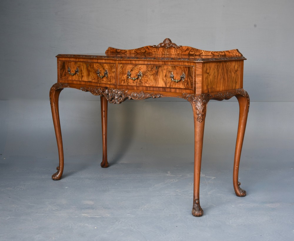 A Queen Anne style burr walnut side table featuring two drawers with brass handles, carved cabriole legs, and a raised gallery top. View III