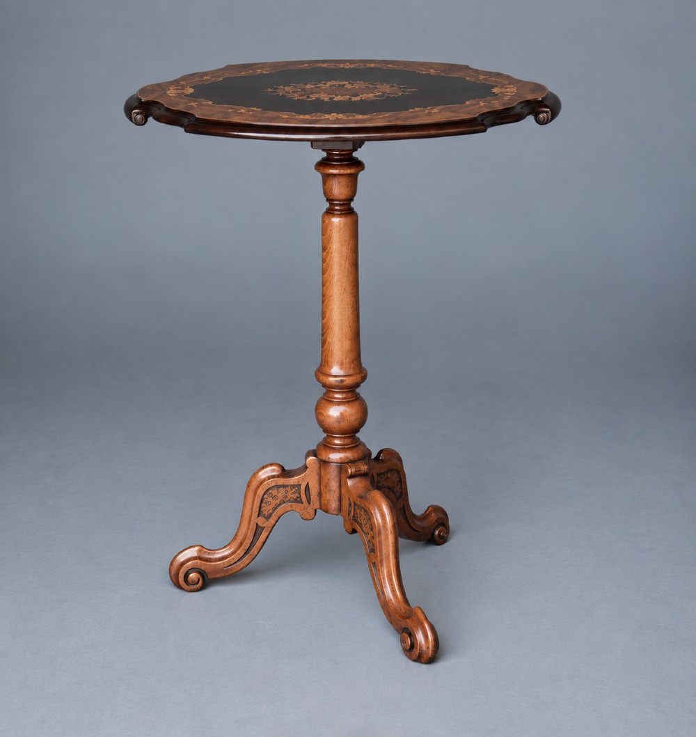 A Victorian walnut wine table with a scalloped edge tabletop decorated with floral marquetry inlay on a turned pedestal and tripod base.