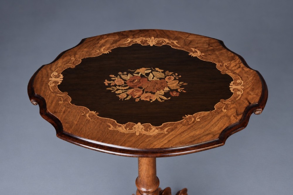 A Victorian walnut wine table with a scalloped edge tabletop decorated with floral marquetry inlay on a turned pedestal and tripod base. View II
