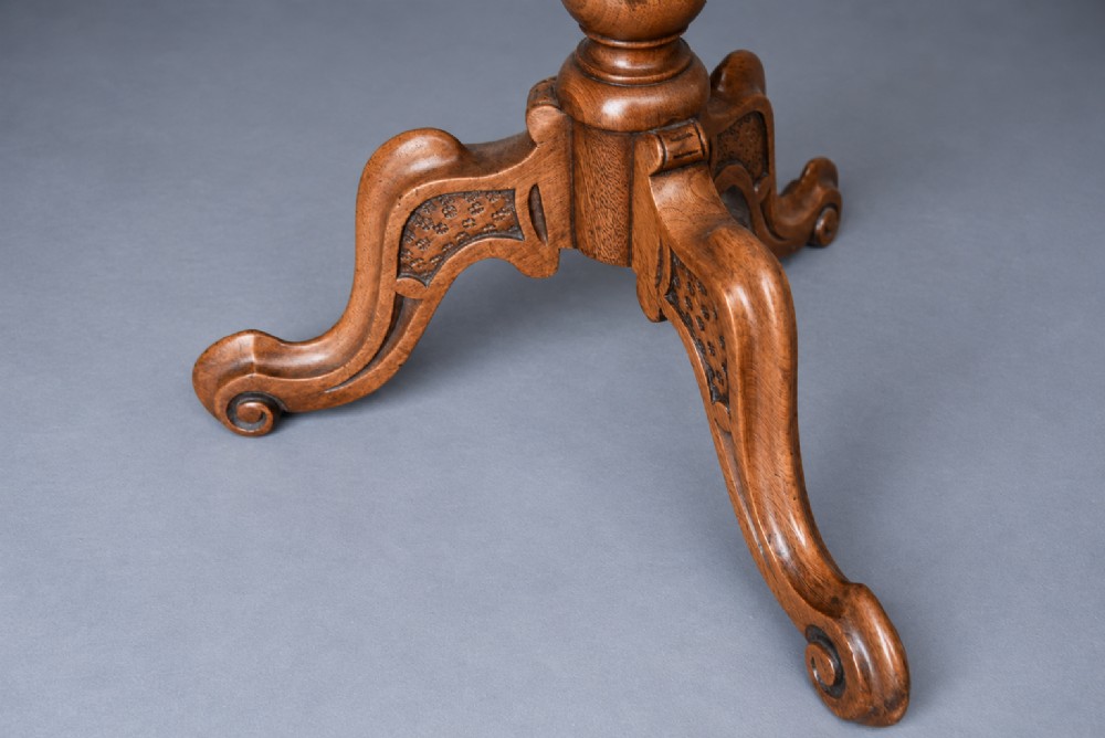 A Victorian walnut wine table with a scalloped edge tabletop decorated with floral marquetry inlay on a turned pedestal and tripod base. View IV