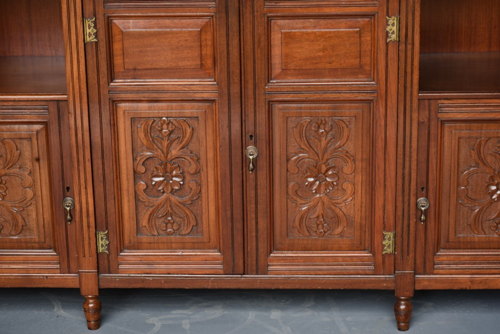 A carved Victorian walnut sideboard with a three-panel mirrored superstructure, spindle galleries, and lower cupboard doors decorated with floral carved panels. View III
