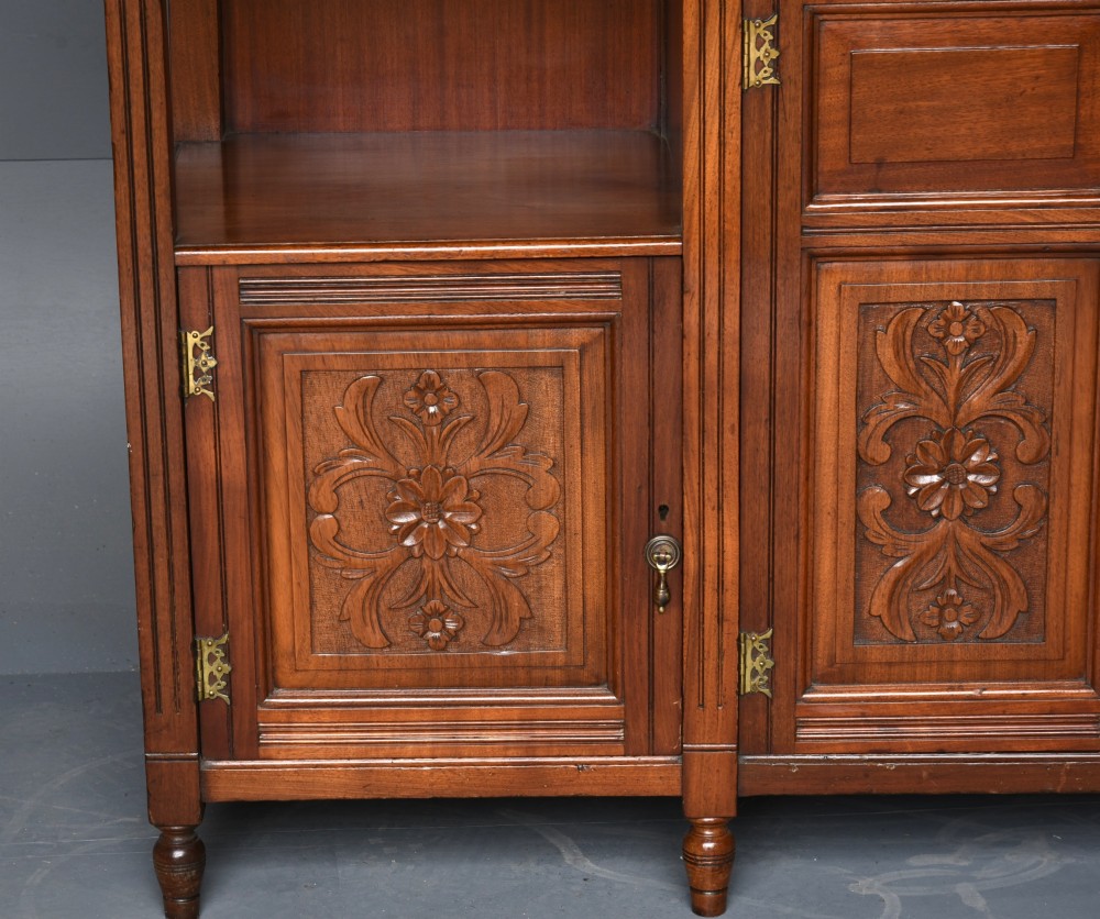 A carved Victorian walnut sideboard with a three-panel mirrored superstructure, spindle galleries, and lower cupboard doors decorated with floral carved panels. View IV